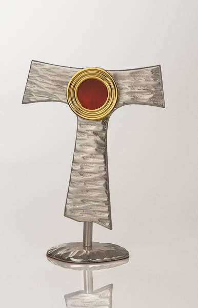 Relikwiarz mosiężny w kształcie franciszakńskiego symbolu o wysokości 20 cm